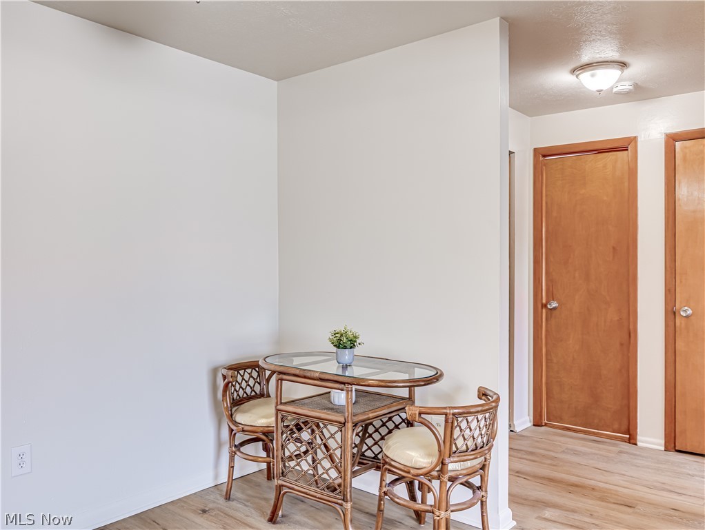 5382 Lee Road, Unit 204 Maple Heights, OH 44137 - Photo 11 of 15 Dining space featuring light wood finished floors and baseboards