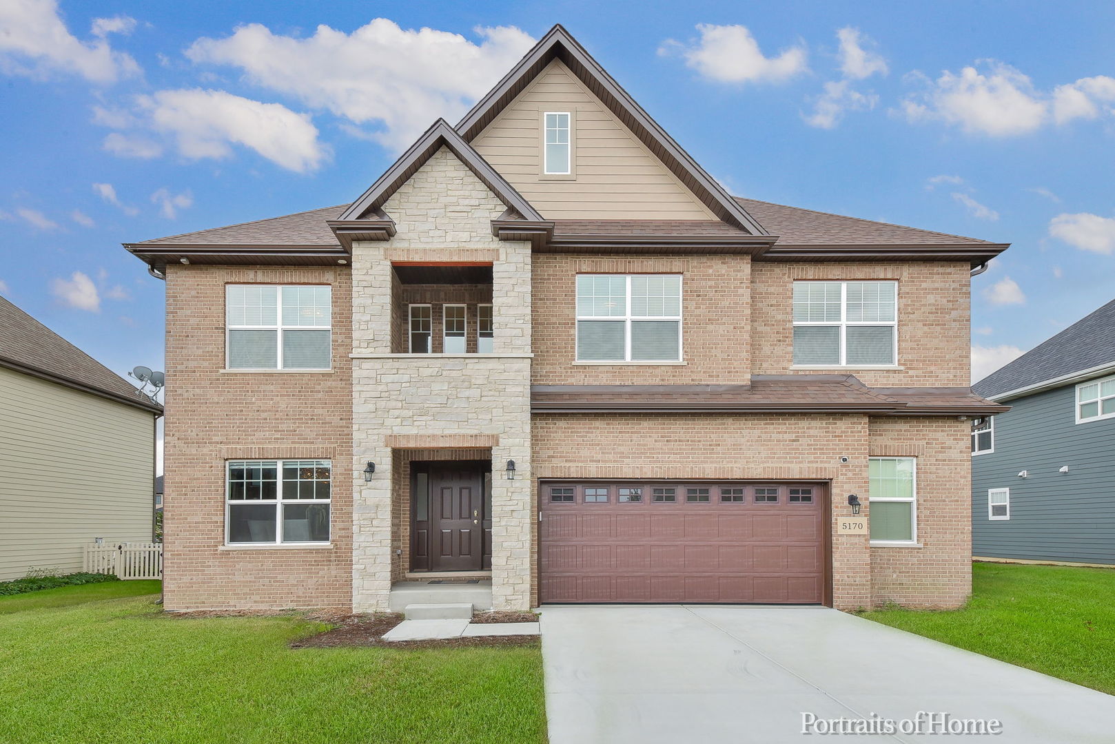 a front view of a house with a garden and yard