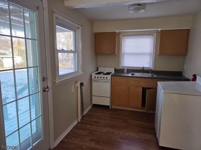a kitchen with a stove a sink and a refrigerator