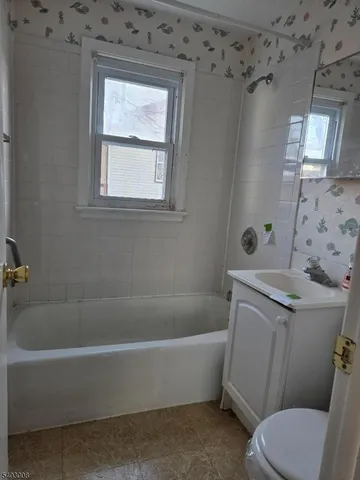 a white bath tub sitting next to a toilet