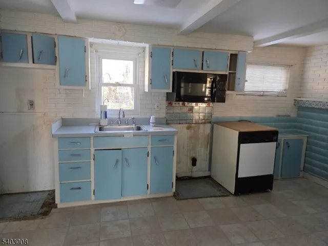 a kitchen with a sink stove and microwave
