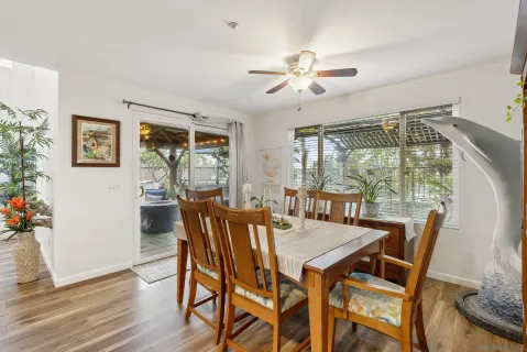a dining room with furniture a window and wooden floor