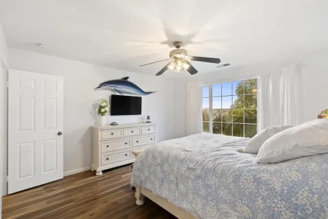 a bedroom with a bed and a chandelier