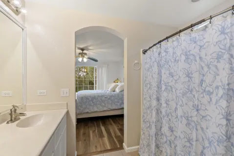 a en suite bathroom with a double vanity sink a mirror and a bathtub