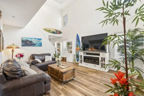 a living room with furniture a flat screen tv and a fireplace