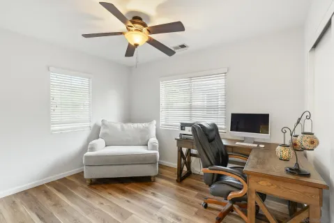 a bedroom with a bed and a ceiling fan
