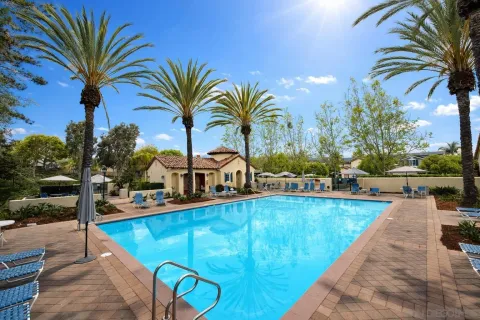 a view of a backyard with swimming pool