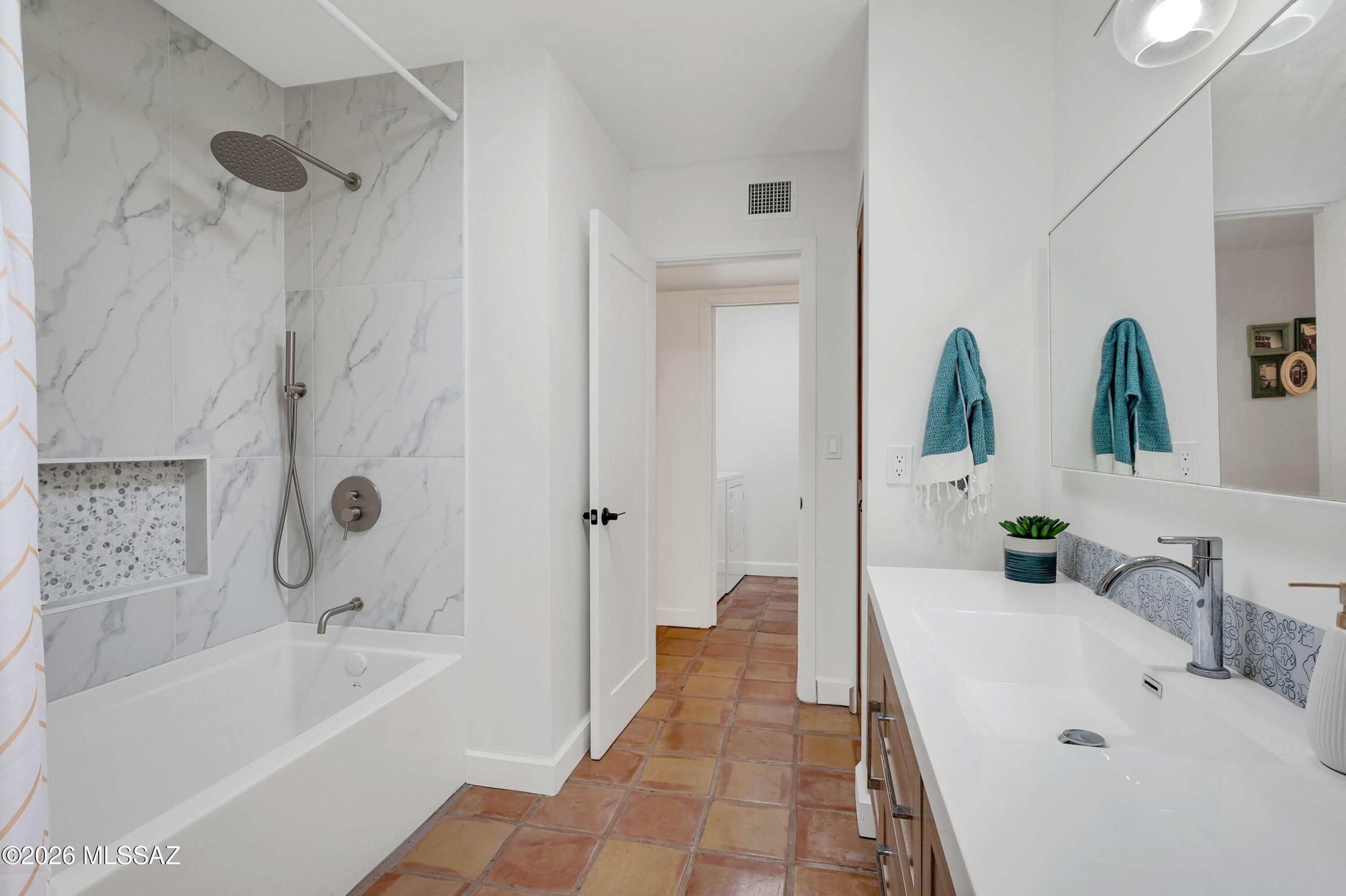 6941 East Rivercrest Road Tucson, AZ 85750 - Photo 13 of 32 a bathroom with a tub sink and mirror