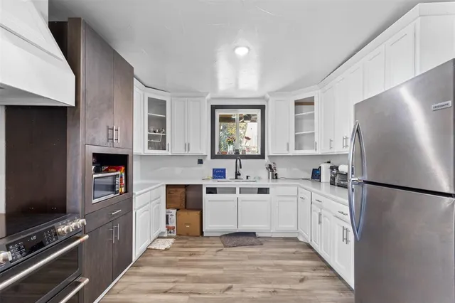 a kitchen with stainless steel appliances a refrigerator stove and sink
