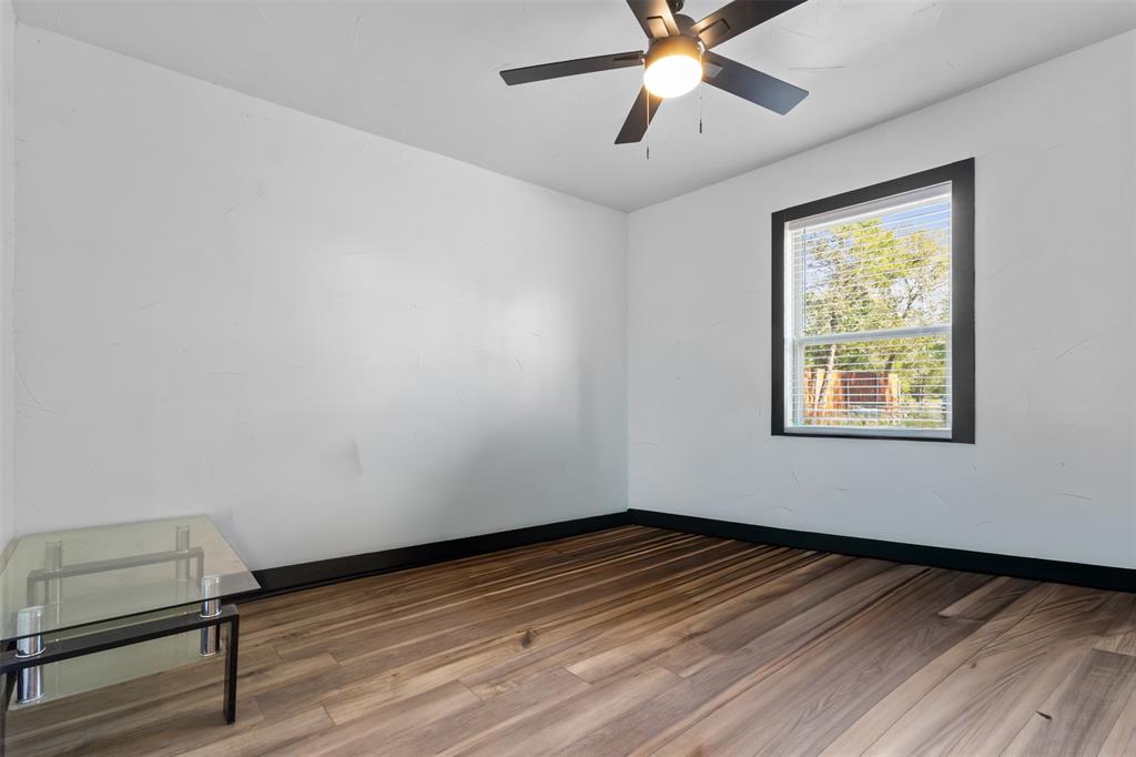 3300 Jordan Valley Road Dallas, TX 75253 - Photo 14 of 25 a view of an empty room with wooden floor and a window