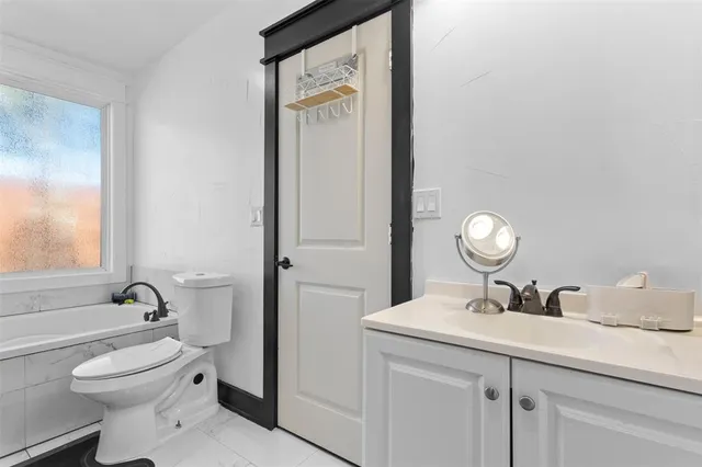 a bathroom with a toilet a sink and a mirror