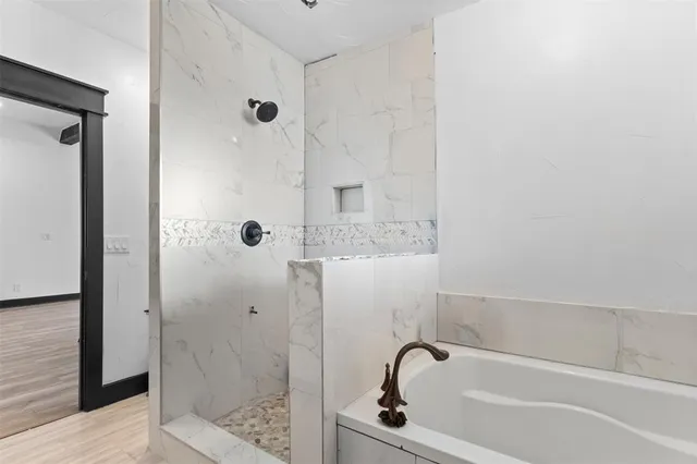 a bathroom with a tub and shower