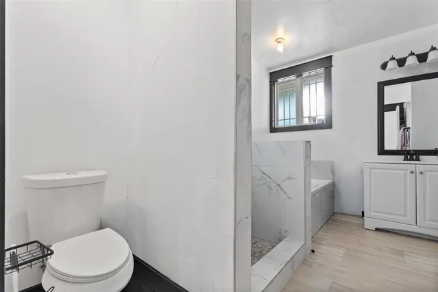 a white toilet sitting next to a bathroom sink