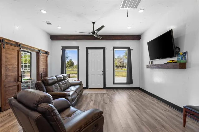 a living room with furniture and a flat screen tv