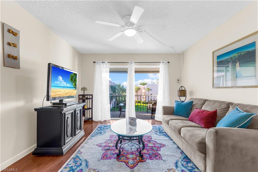 a living room with furniture a rug and a flat screen tv