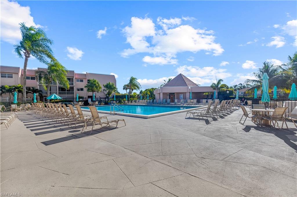 150 Turtle Lake Court, Unit 307 Naples, FL 34105 - Photo 16 of 27 a front view of a house with garden and patio