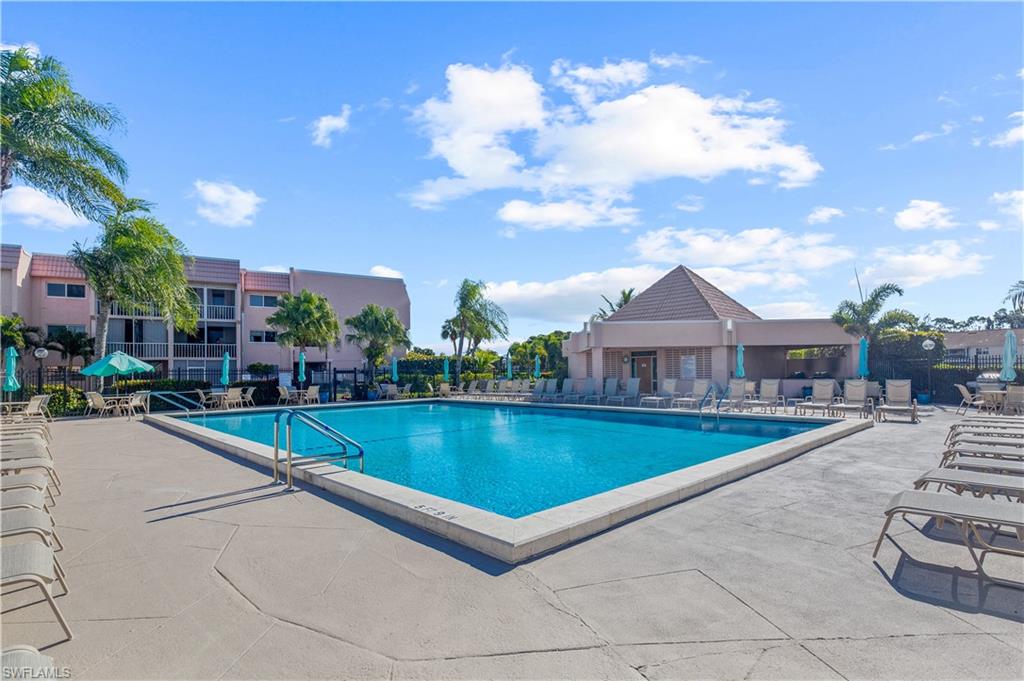 150 Turtle Lake Court, Unit 307 Naples, FL 34105 - Photo 17 of 27 a view of a house with swimming pool