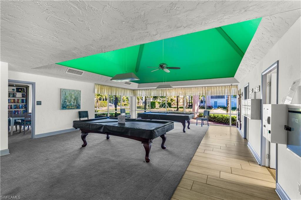 150 Turtle Lake Court, Unit 307 Naples, FL 34105 - Photo 20 of 27 a patio with patio table and chairs