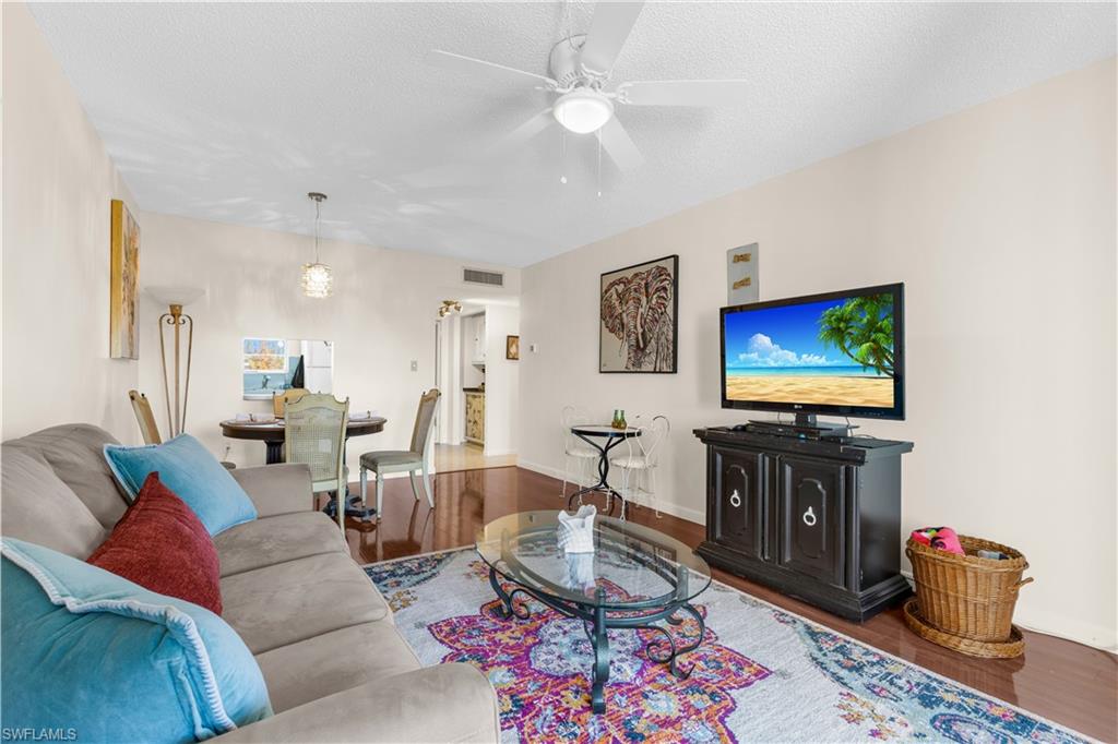 150 Turtle Lake Court, Unit 307 Naples, FL 34105 - Photo 2 of 27 a living room with furniture and a flat screen tv