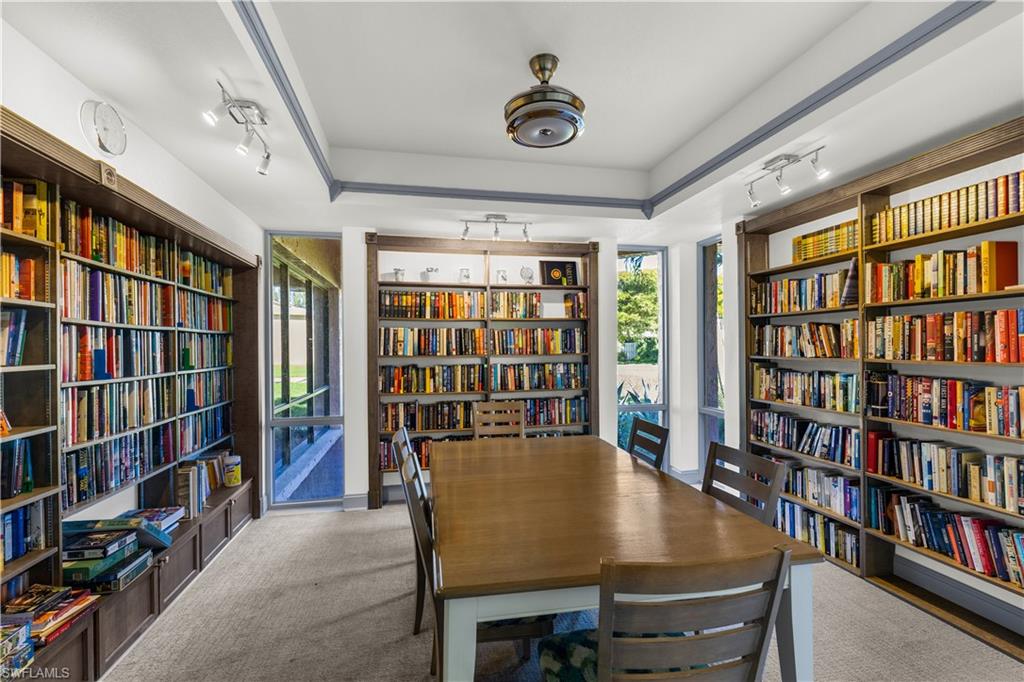 150 Turtle Lake Court, Unit 307 Naples, FL 34105 - Photo 21 of 27 a view of a dining room with furniture and book shelf