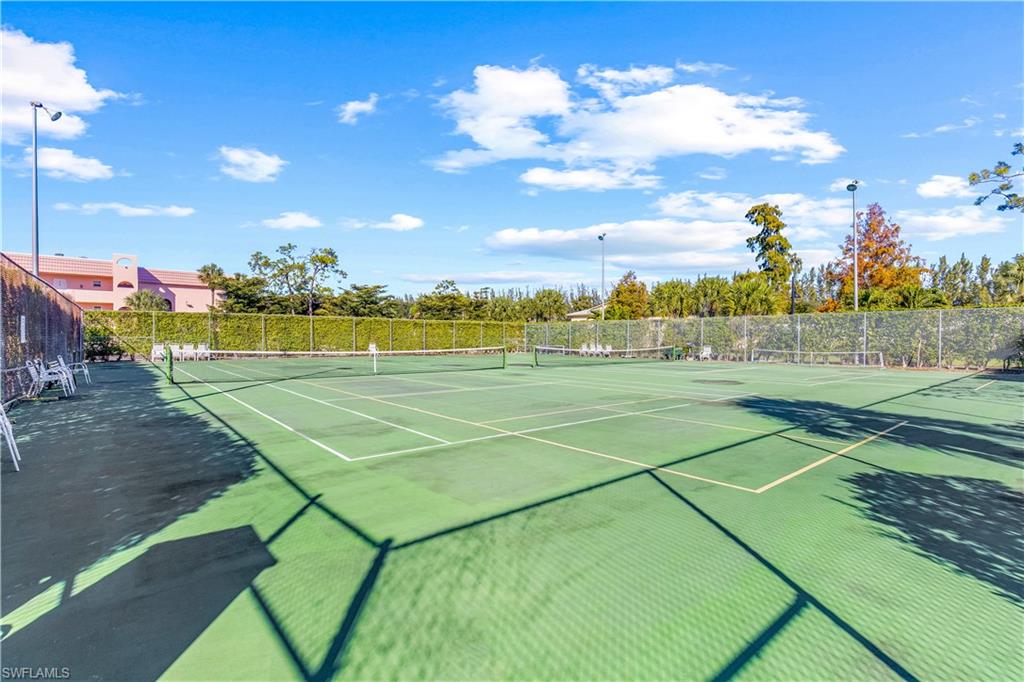 150 Turtle Lake Court, Unit 307 Naples, FL 34105 - Photo 24 of 27 a view of an outdoor space and tennis court