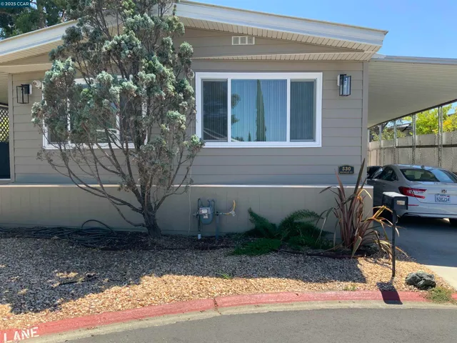 a view of a car park in front of a house