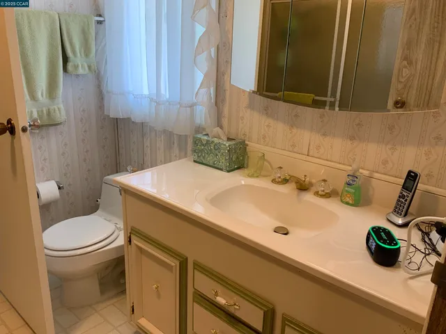 a bedroom with a bed and a flat tv screen on the dresser