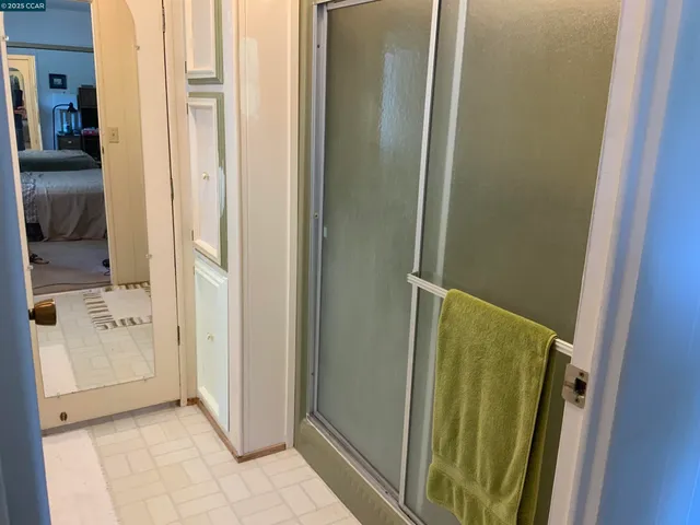 a bedroom with a bed and a television