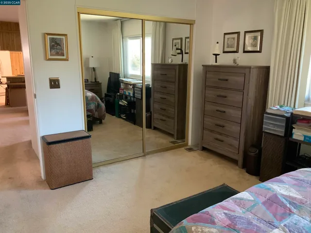 a view of a hallway with couch and closet