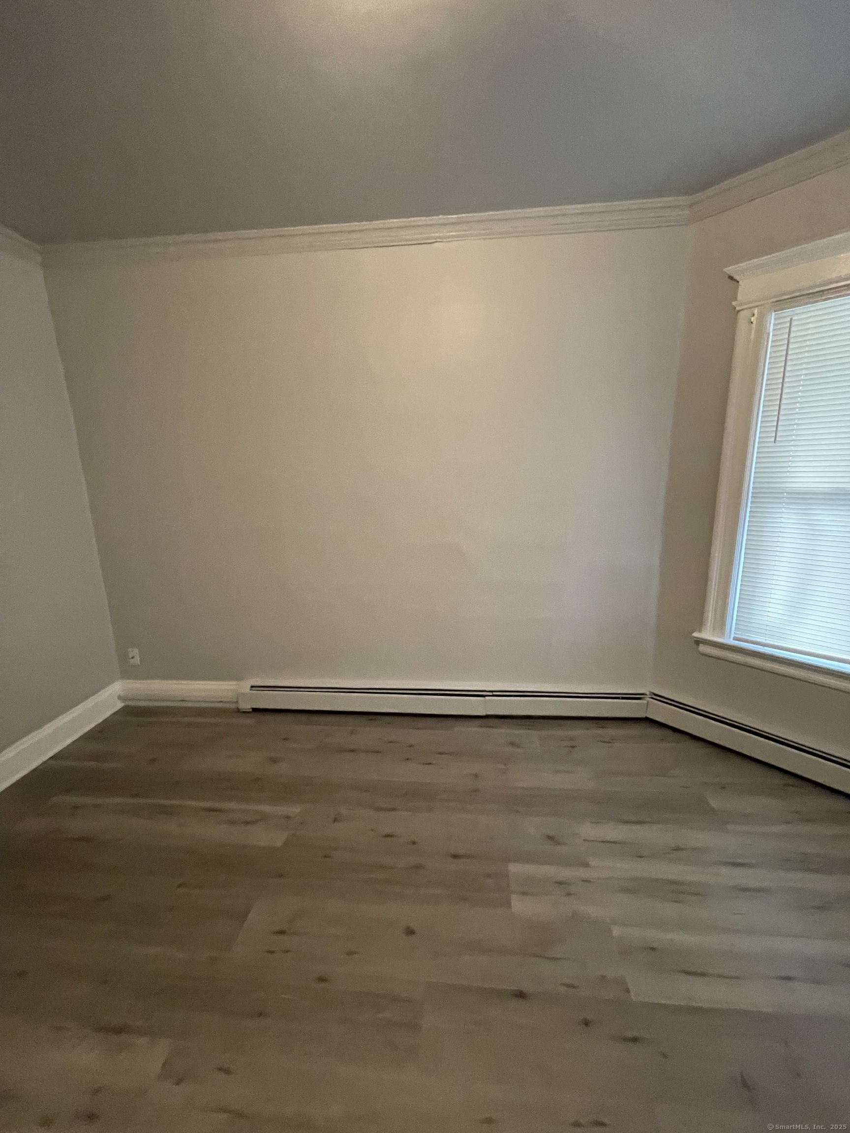 424 Edgewood Street, Unit 1 Hartford, CT 06112 - Photo 2 of 10 a view of an empty room with wooden floor and a window