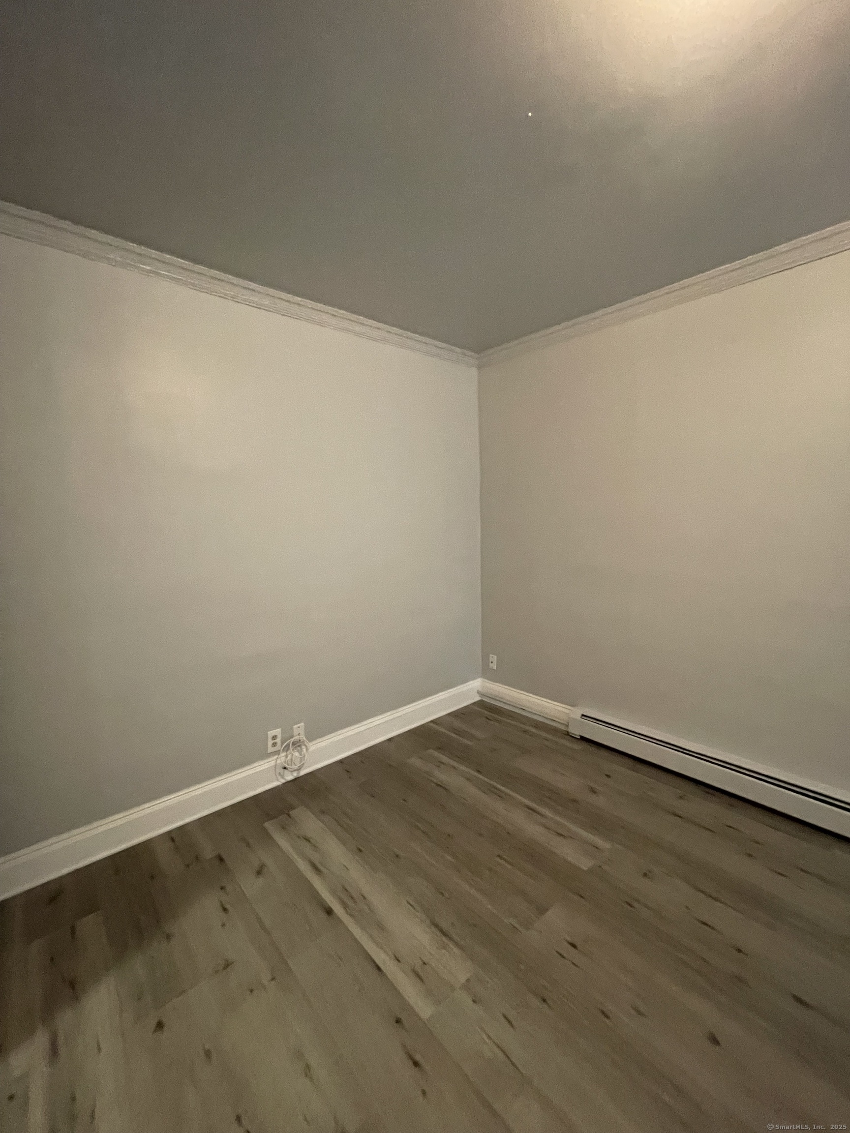 424 Edgewood Street, Unit 1 Hartford, CT 06112 - Photo 3 of 10 a view of an empty room with wooden floor