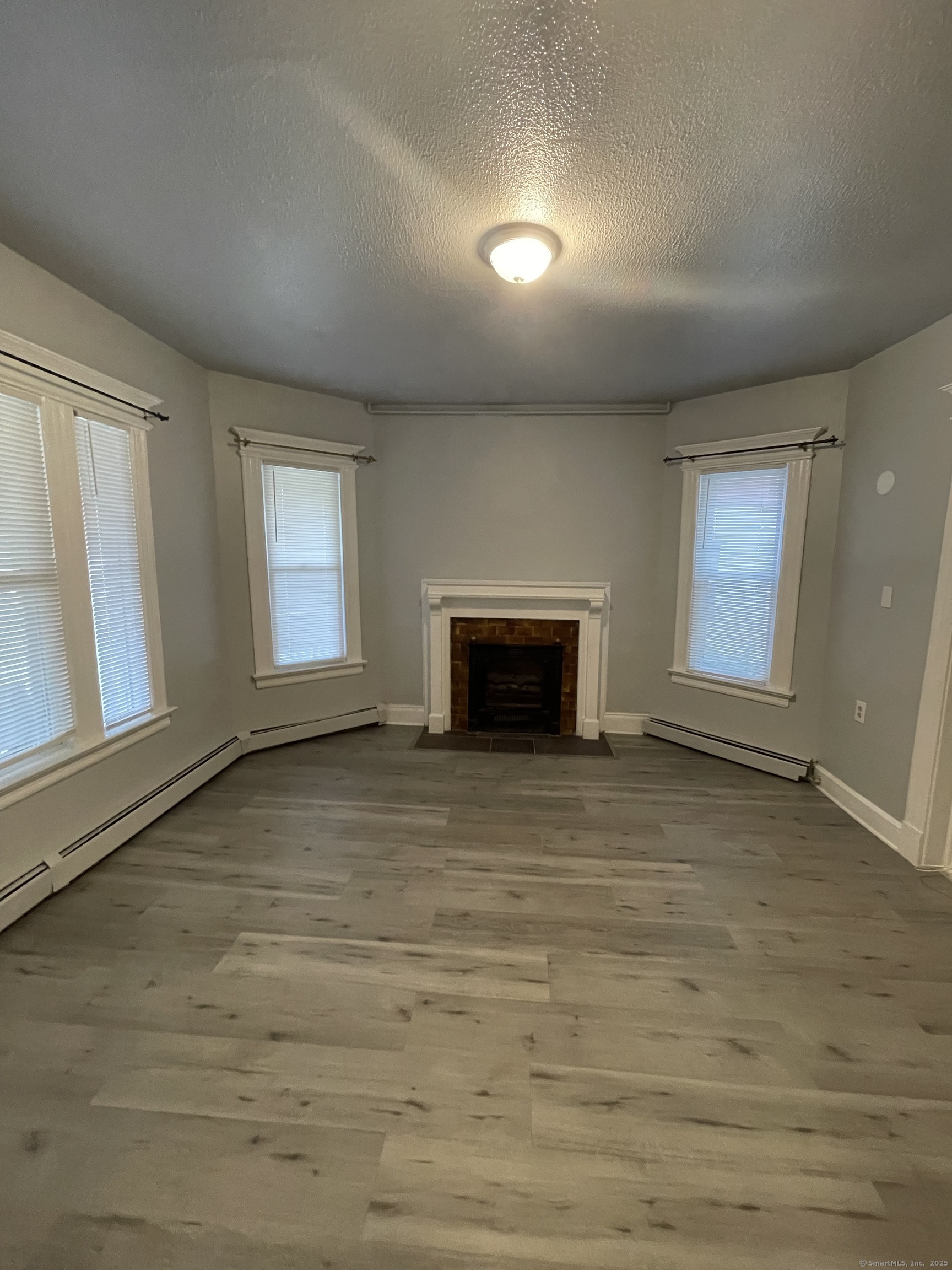 424 Edgewood Street, Unit 1 Hartford, CT 06112 - Photo 7 of 10 an empty room with windows