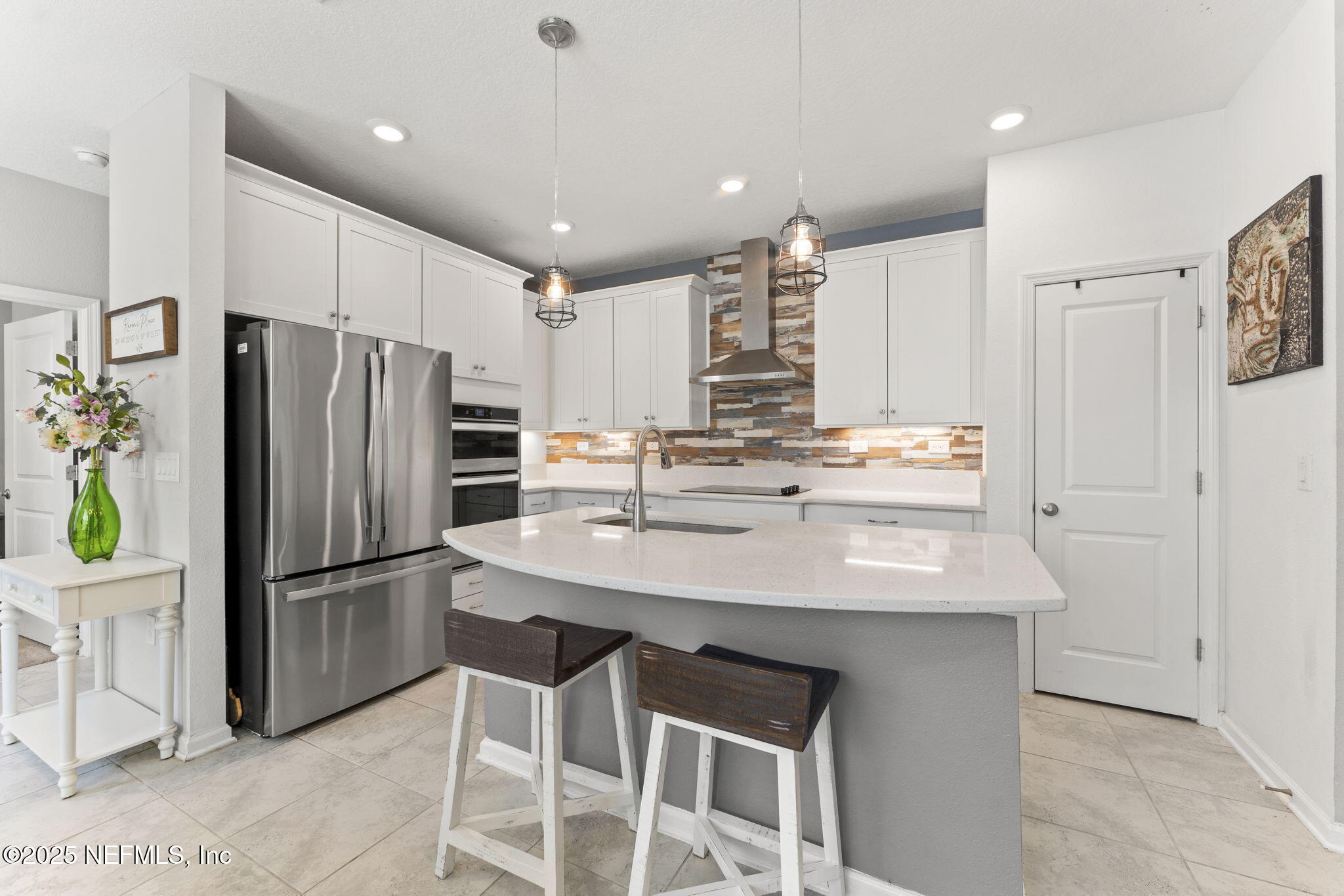 128 Modesto Drive St. Augustine, FL 32086 - Photo 13 of 30 a kitchen with kitchen island a refrigerator stove microwave and cabinets