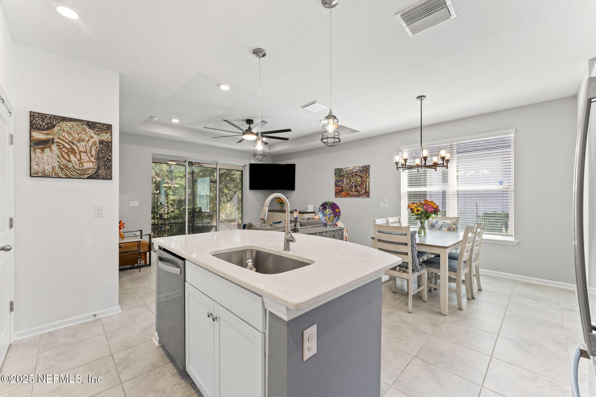 128 Modesto Drive St. Augustine, FL 32086 - Photo 14 of 30 a kitchen with a dining table chairs and white cabinets