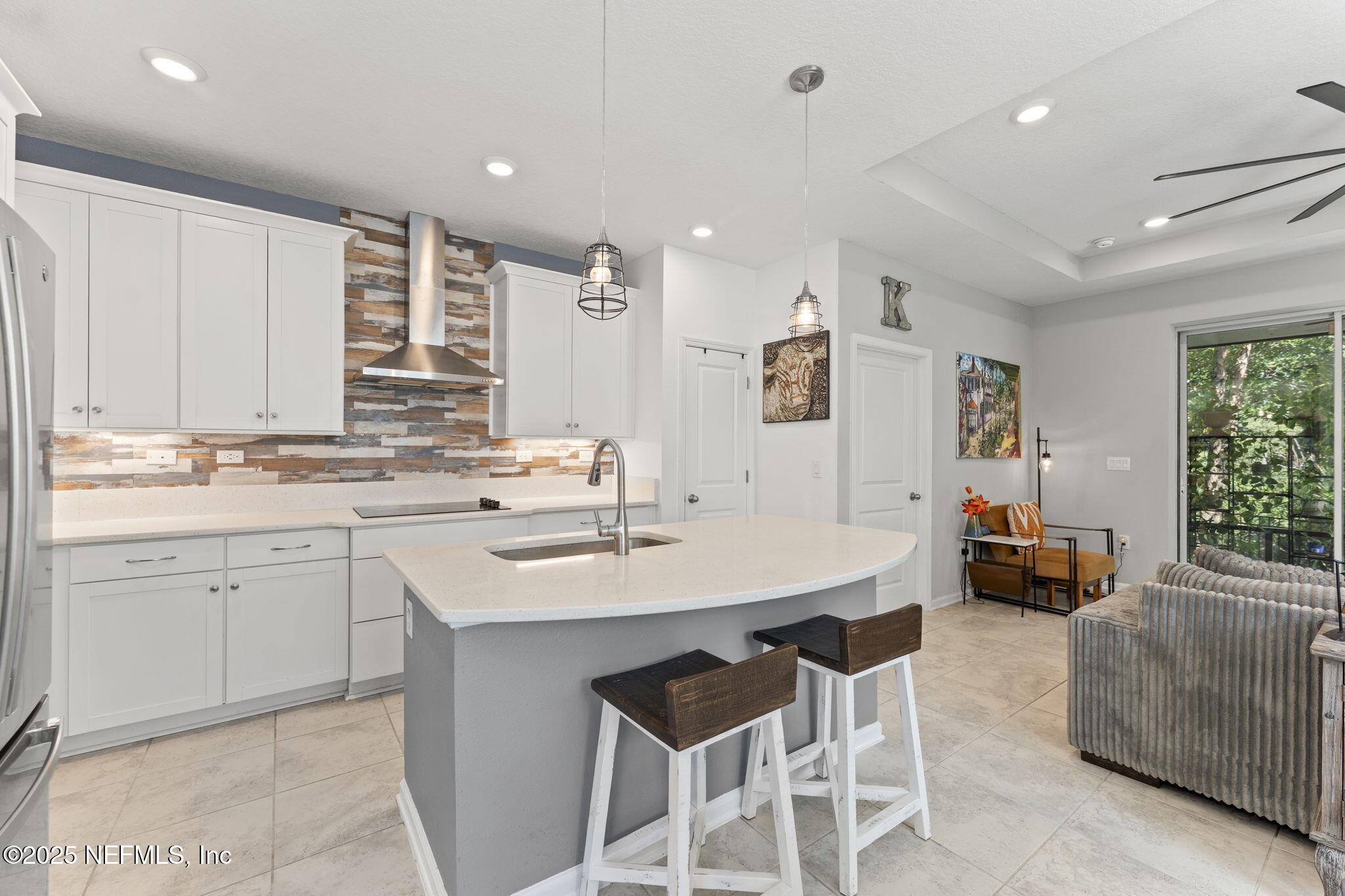 128 Modesto Drive St. Augustine, FL 32086 - Photo 17 of 30 a kitchen with a sink chairs and white cabinets