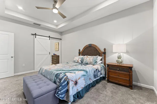 a spacious bedroom with a bed and a window