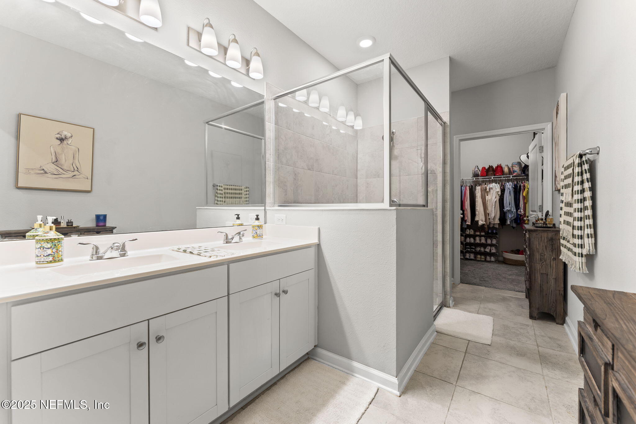 128 Modesto Drive St. Augustine, FL 32086 - Photo 23 of 30 a bathroom with a double vanity sink and a mirror