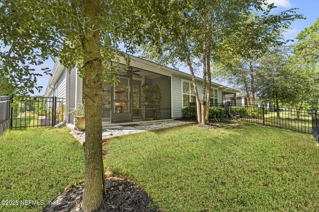 a view of a house with backyard and porch