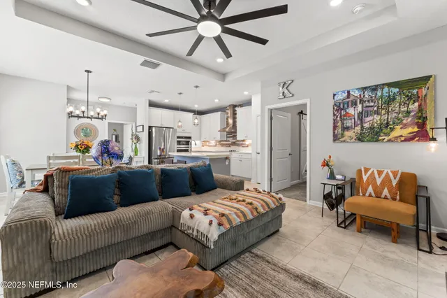 a living room with furniture and kitchen view