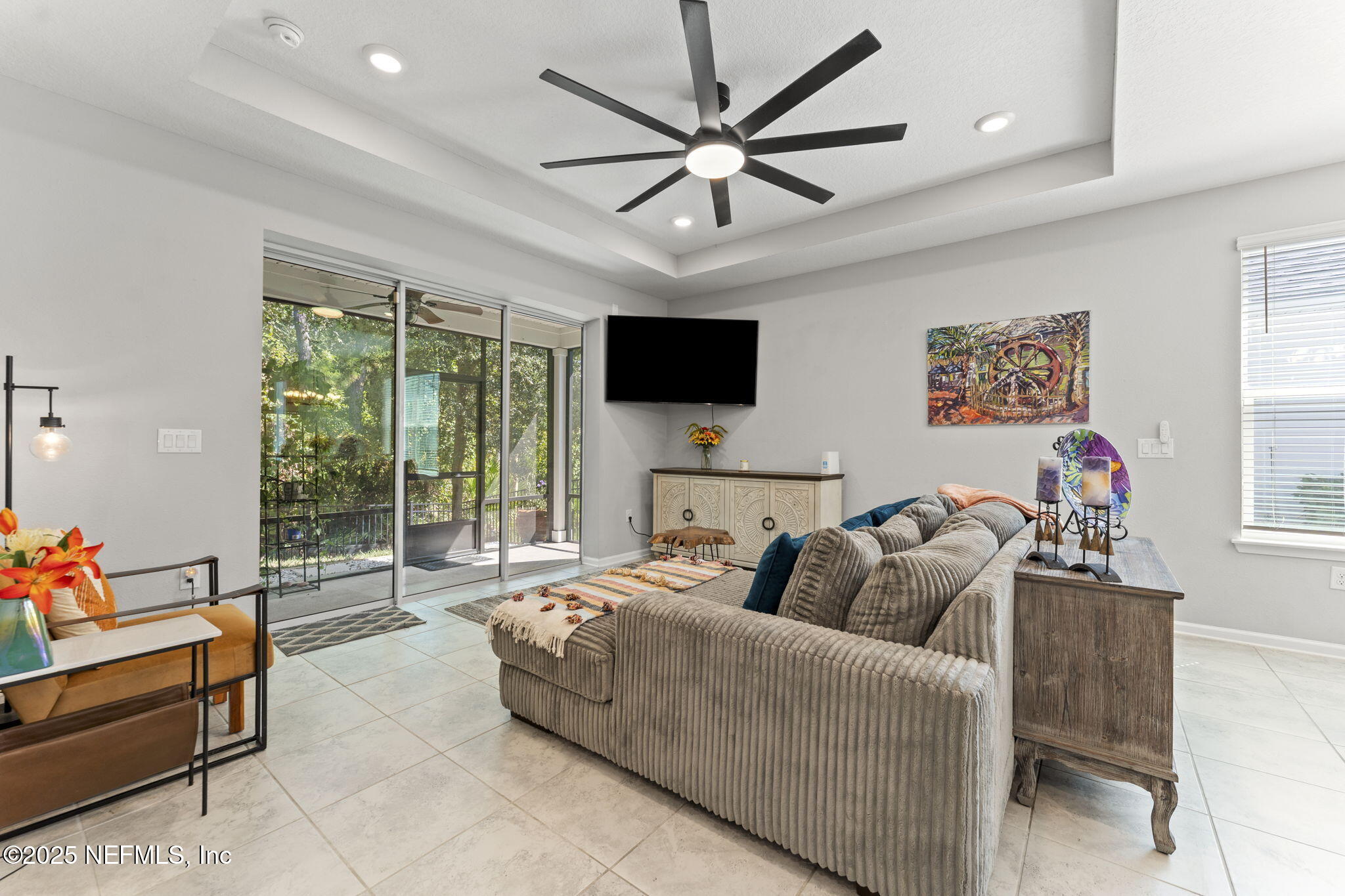 128 Modesto Drive St. Augustine, FL 32086 - Photo 7 of 30 a living room with furniture a flat screen tv and a large window