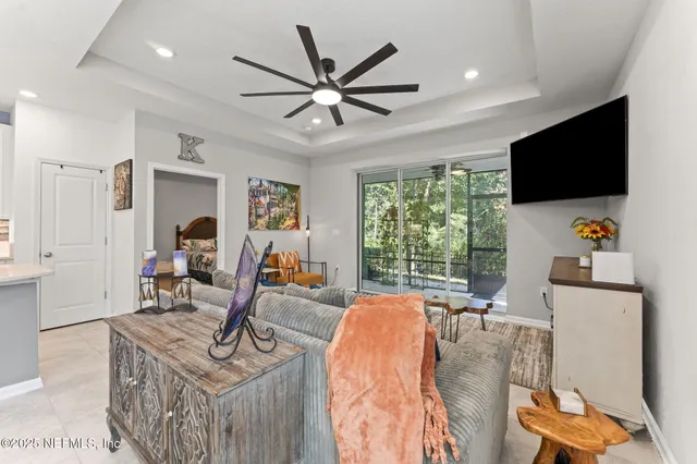 a dining room filled chandelier and kitchen view