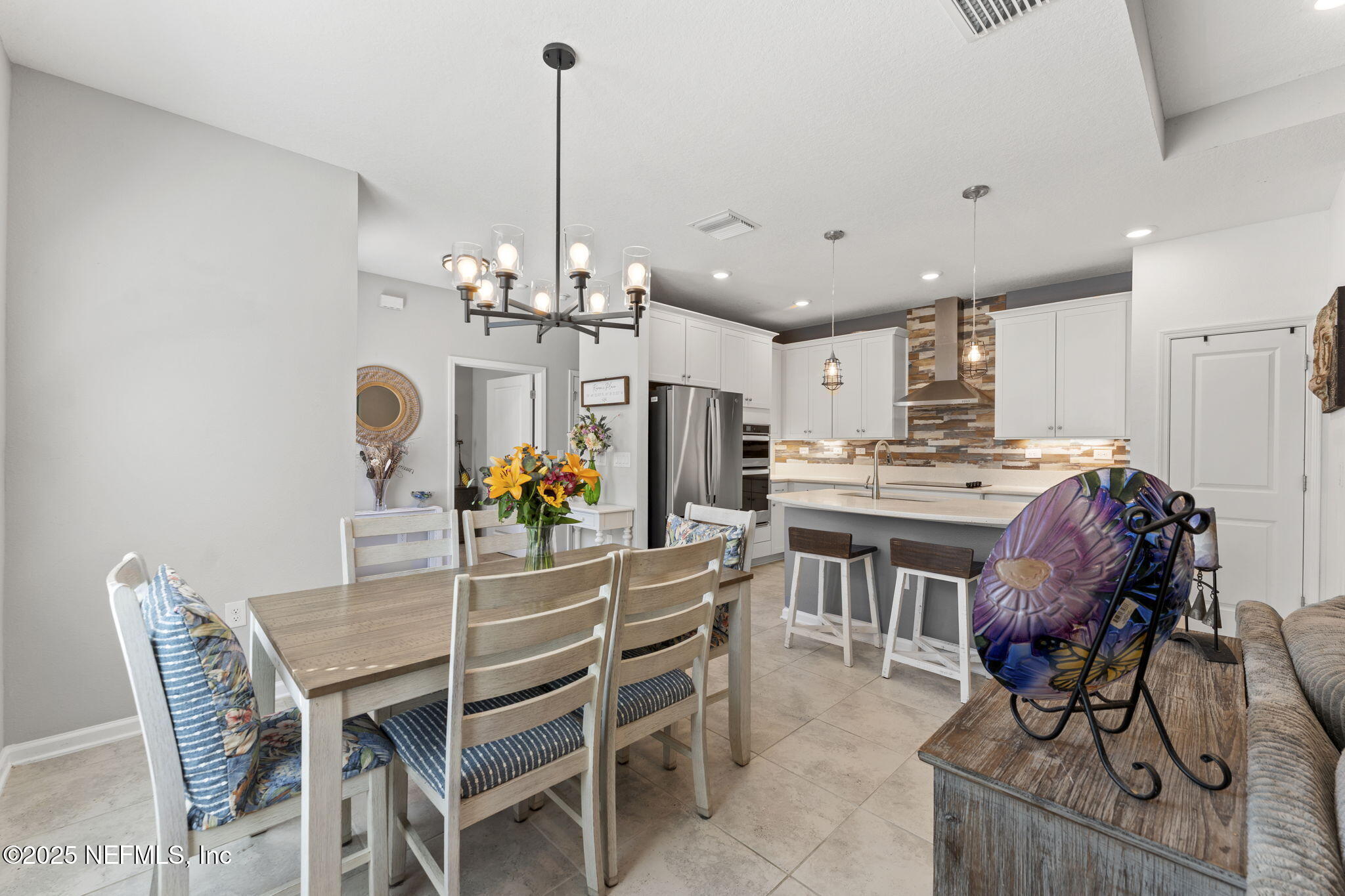128 Modesto Drive St. Augustine, FL 32086 - Photo 9 of 30 a dining room filled chandelier and kitchen view
