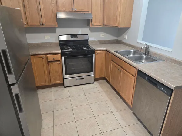 a kitchen with a stove sink and cabinets