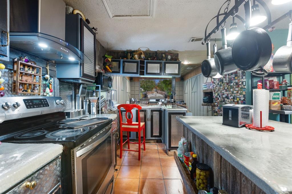 3352 Buckingham Lane Plano, TX 75074 - Photo 11 of 34 a kitchen with stainless steel appliances granite countertop a stove and a sink