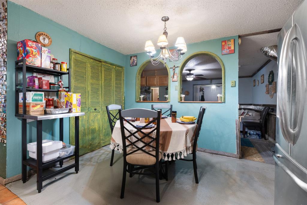 3352 Buckingham Lane Plano, TX 75074 - Photo 13 of 34 a view of a dining room with furniture and chandelier