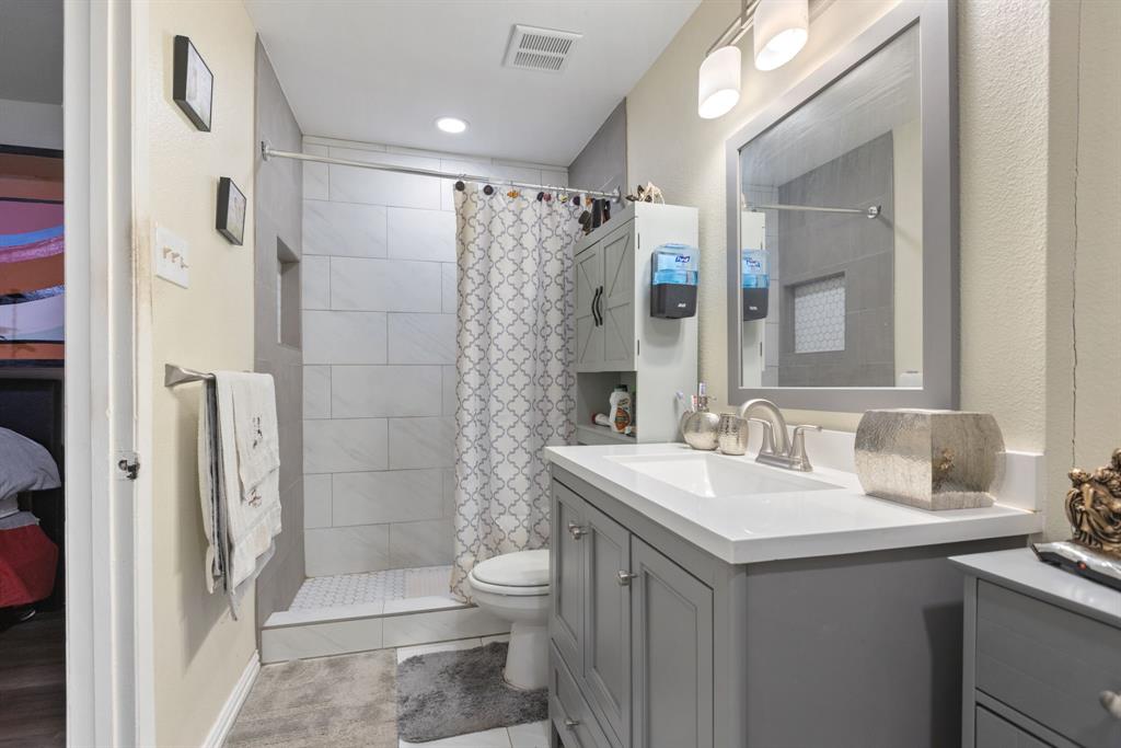3352 Buckingham Lane Plano, TX 75074 - Photo 18 of 34 a bathroom with a sink toilet and shower
