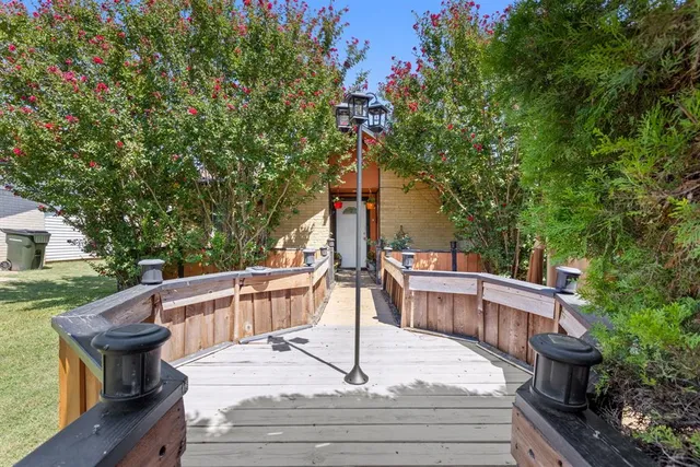 a view of house with backyard and sitting area