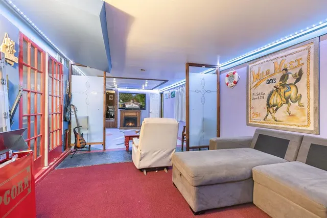 a bedroom with furniture and a large window