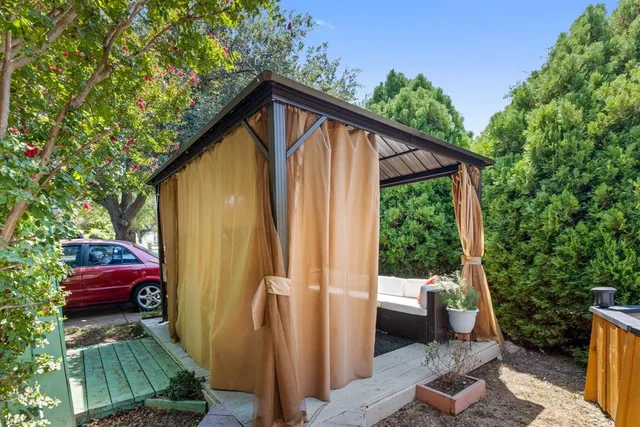 a view of backyard with outdoor seating and plants