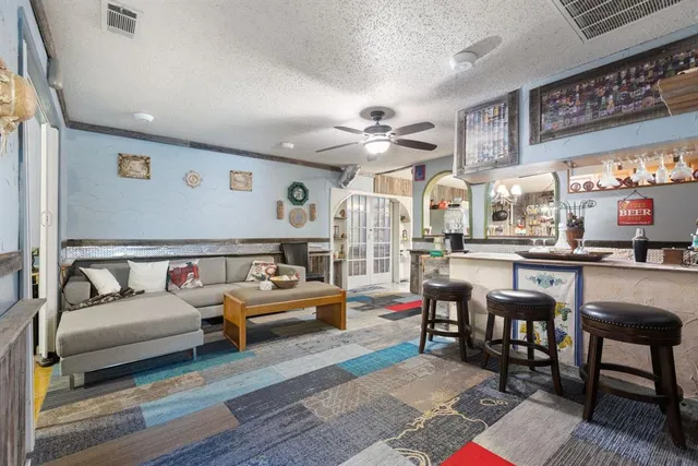 a living room with furniture and kitchen view